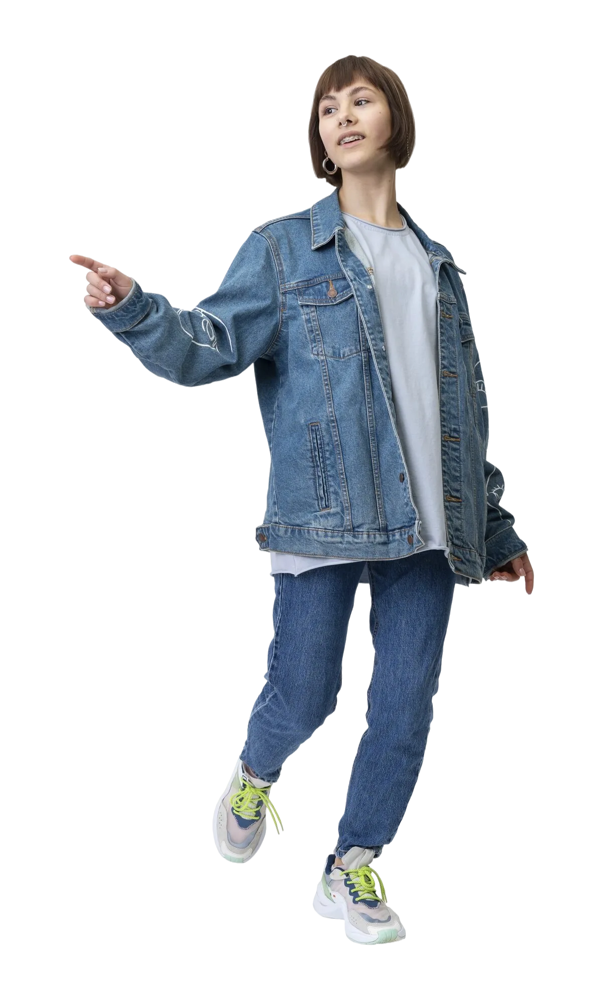 Young woman in an oversized denim jacket and jeans, pointing to the side